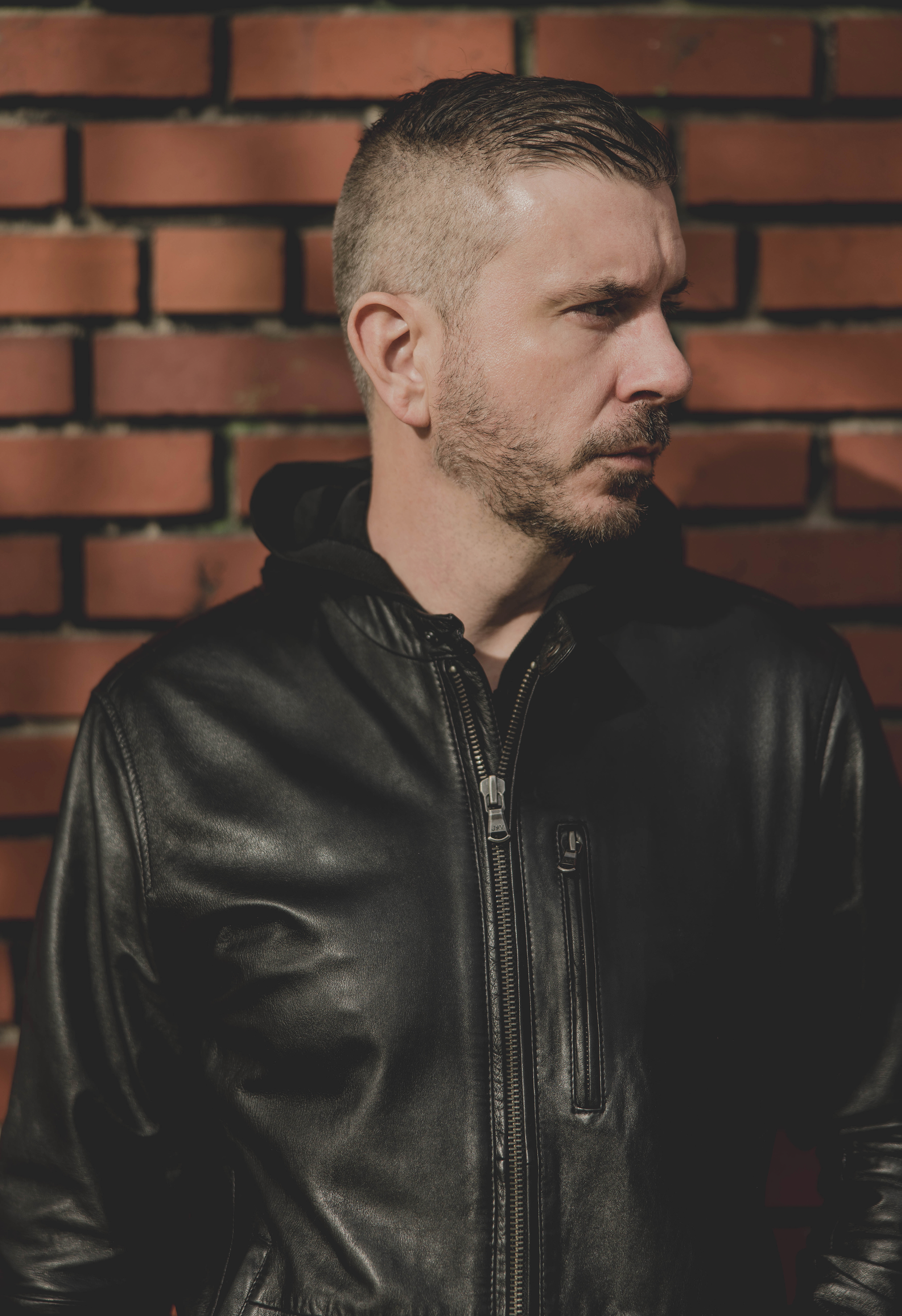 William White side profile — brick wall