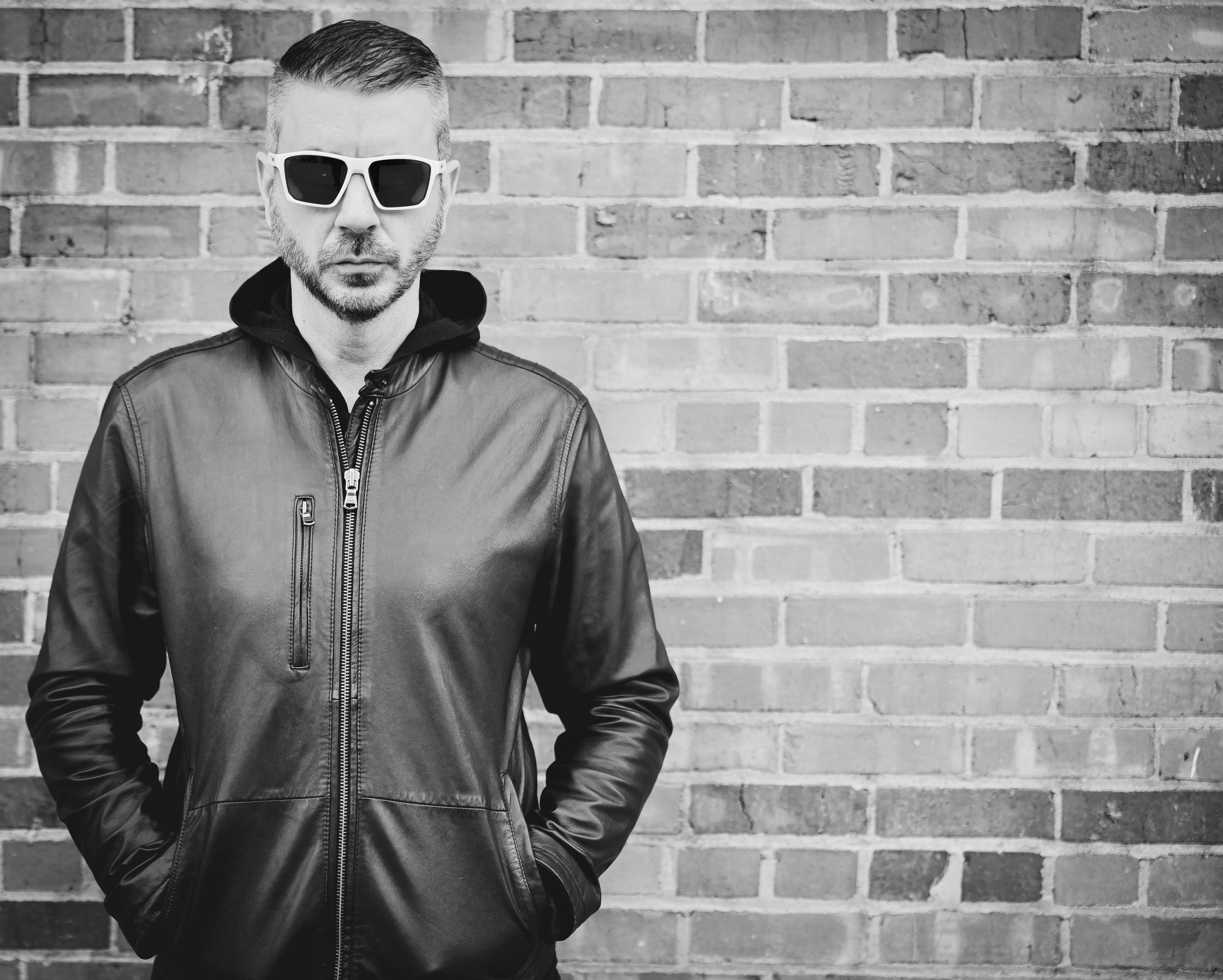 William White sunglasses monochrome — brick wall