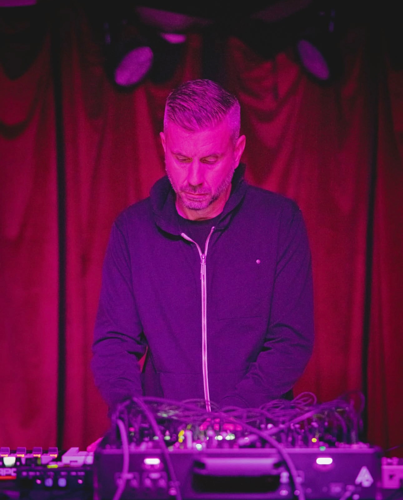 William White performing live — pink stage lighting